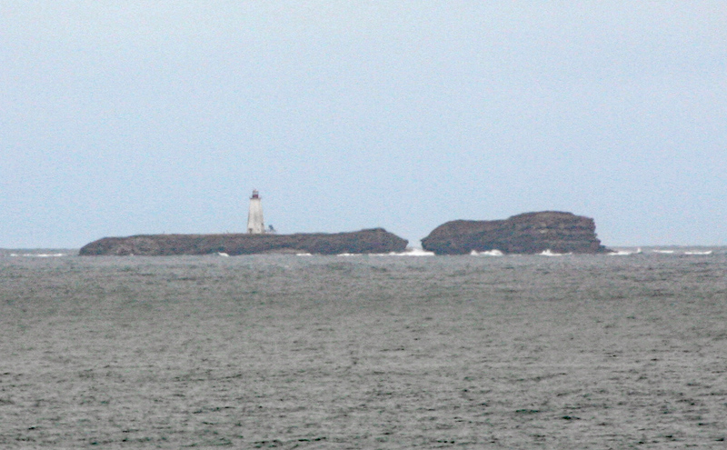 Flint Island from afar with the small view of a lighthouse