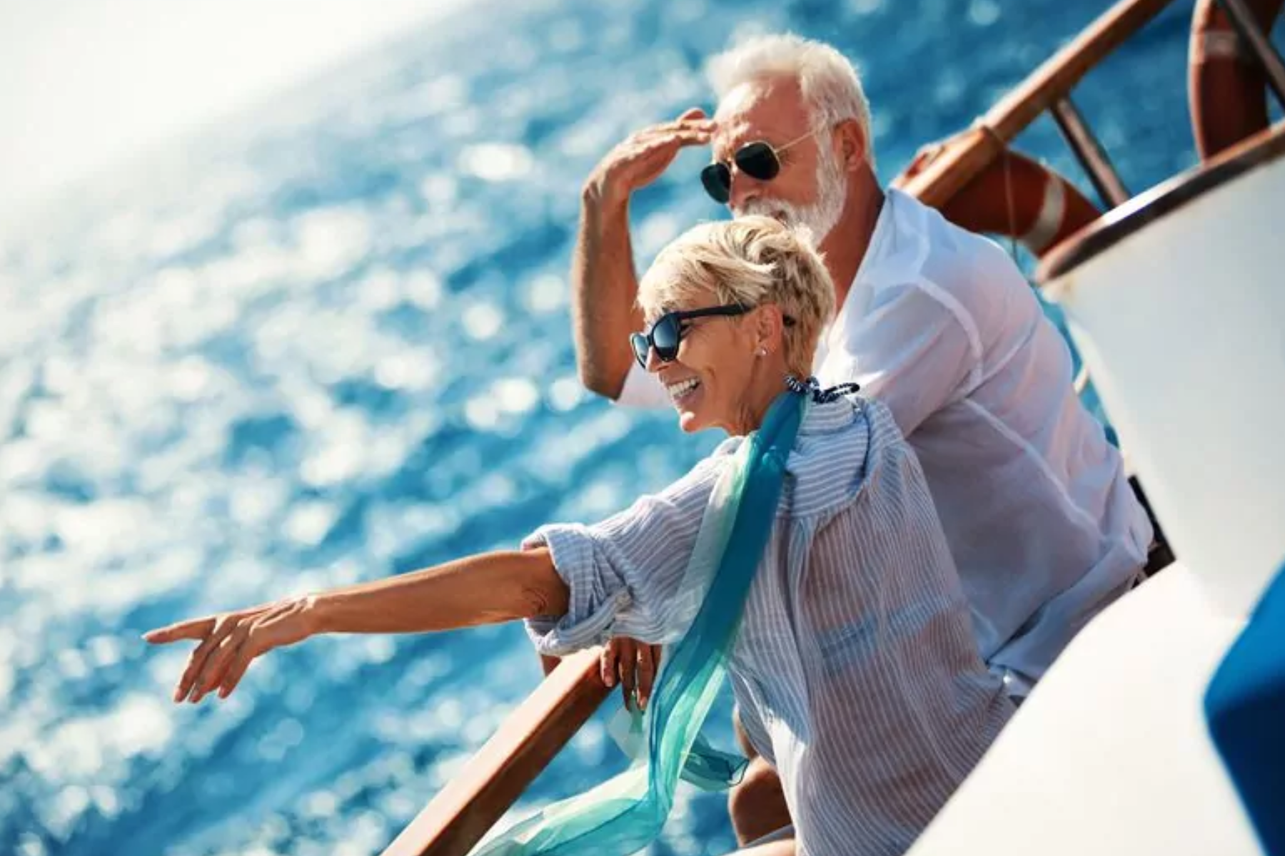 An elderly couple on a cruise ship staring far away