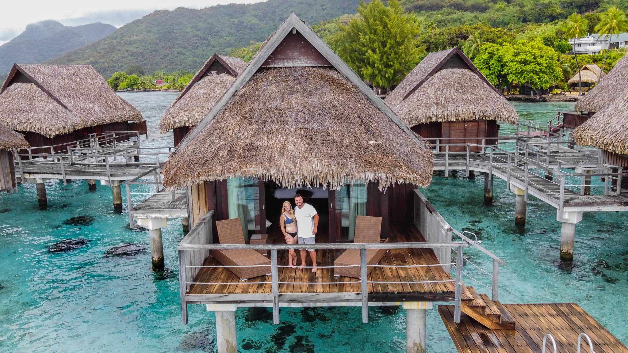 A couple in an overwater bungalow in Moorea, French Polynesia