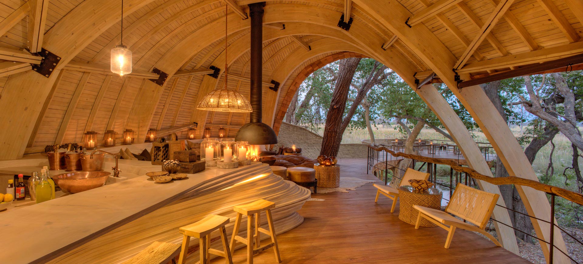 Sandibe Okavango Safari Lodge, a cozy lodge with lit candles and a view of the Safari