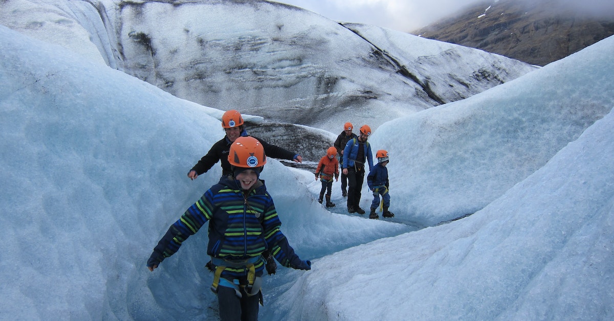 A family wearing safety gears, glacier hiking on Vatnajökull, Iceland