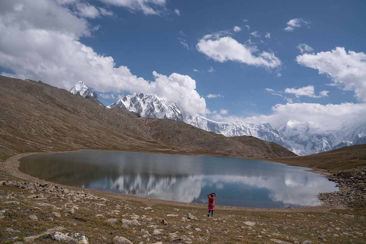 A woman standing near a lake