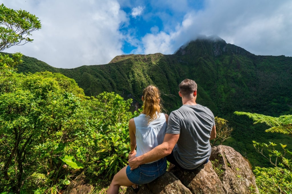 A couple sitting on a rock on an island in Saint Kitts & Nevis