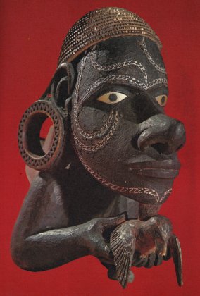 A carved canoe prow ornament of blackened wood inlaid with mother-of-pearl from Maravo lagoon in New Georgia, Solomon Islands. Attached just above the waterline, it represented the protector spirit of the canoe