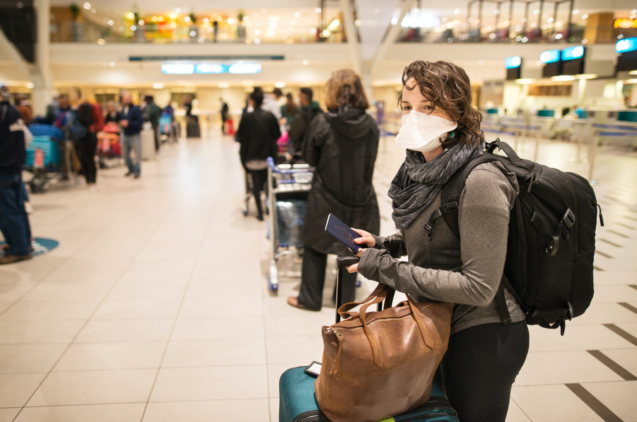Woman in the airport wearing a mask