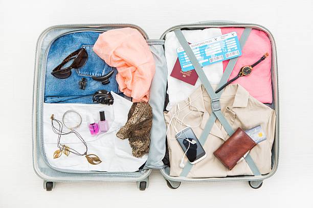 An open suitcase with clothes and other travel essentials.